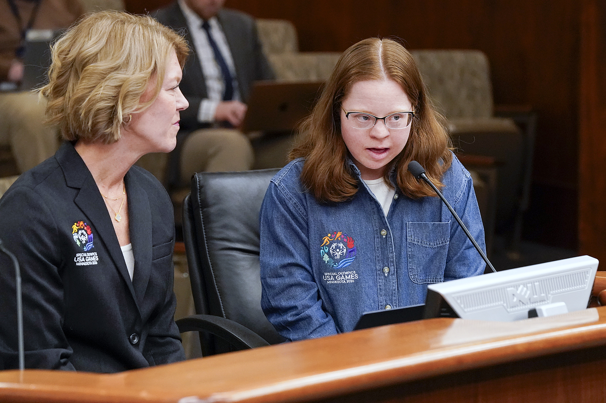 Special Olympics athlete Abby Hirsch testifies before the House economic development panel March 27 in support of HF4123. Christy Sovereign, president and CEO of the 2026 Special Olympics USA Games, left, also testified. (Photo by Michele Jokinen)